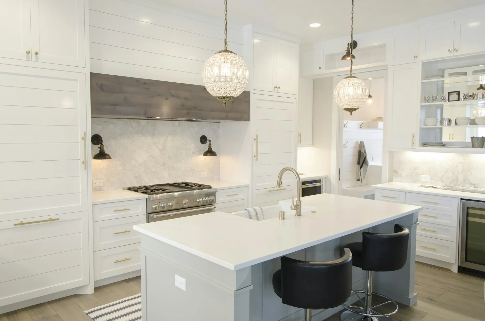 Homeowner and contractor reviewing a wall calendar in a kitchen under renovation