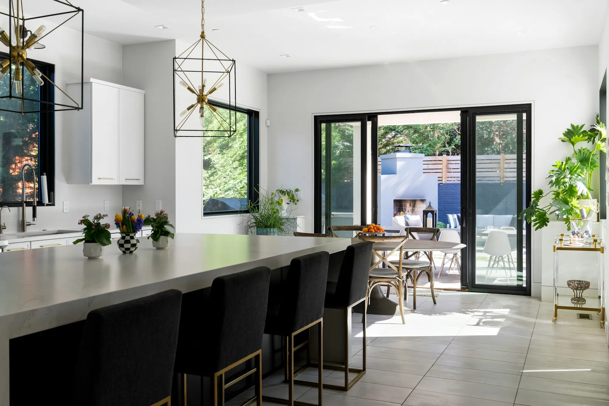 Kitchen with new painted cabinets, stone counters and pendant lights over an island